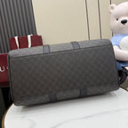 Gray monogram duffel bag with black top handle and side strap
