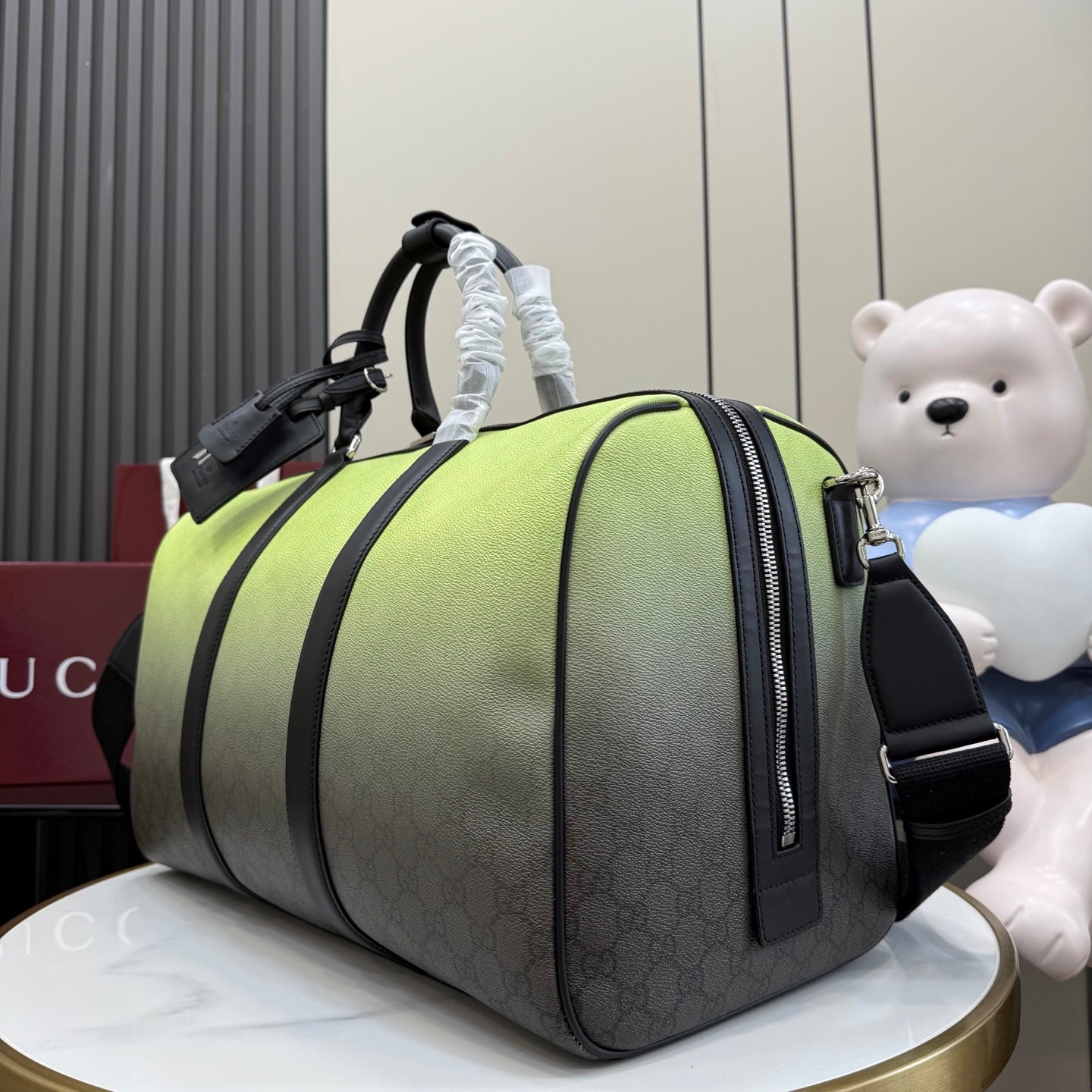 Lime-green and gray monogram duffel bag with zip pocket end and black crossbody strap