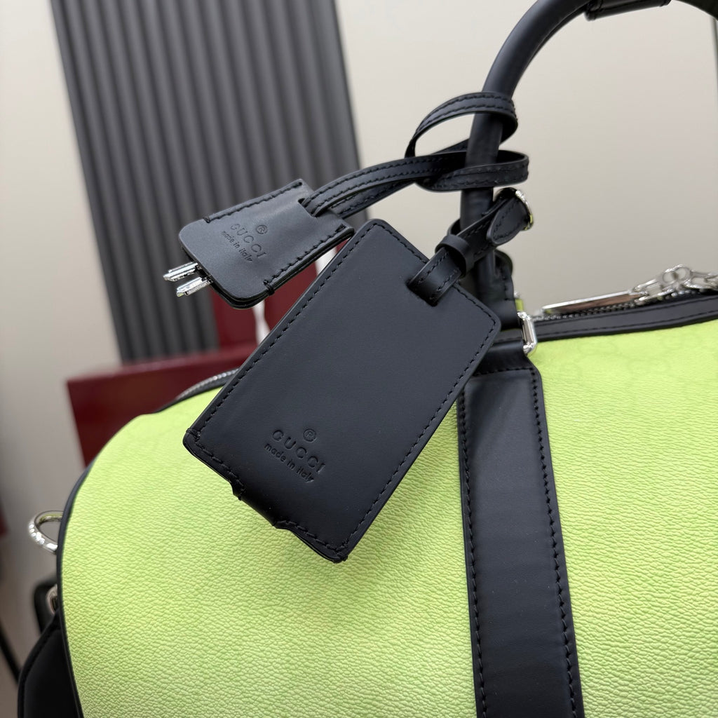 Gucci bag with navy leather strap, zip hardware and hanging label on lime green body