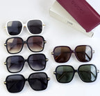 Multiple square sunglasses with assorted frames and tinted lenses on display