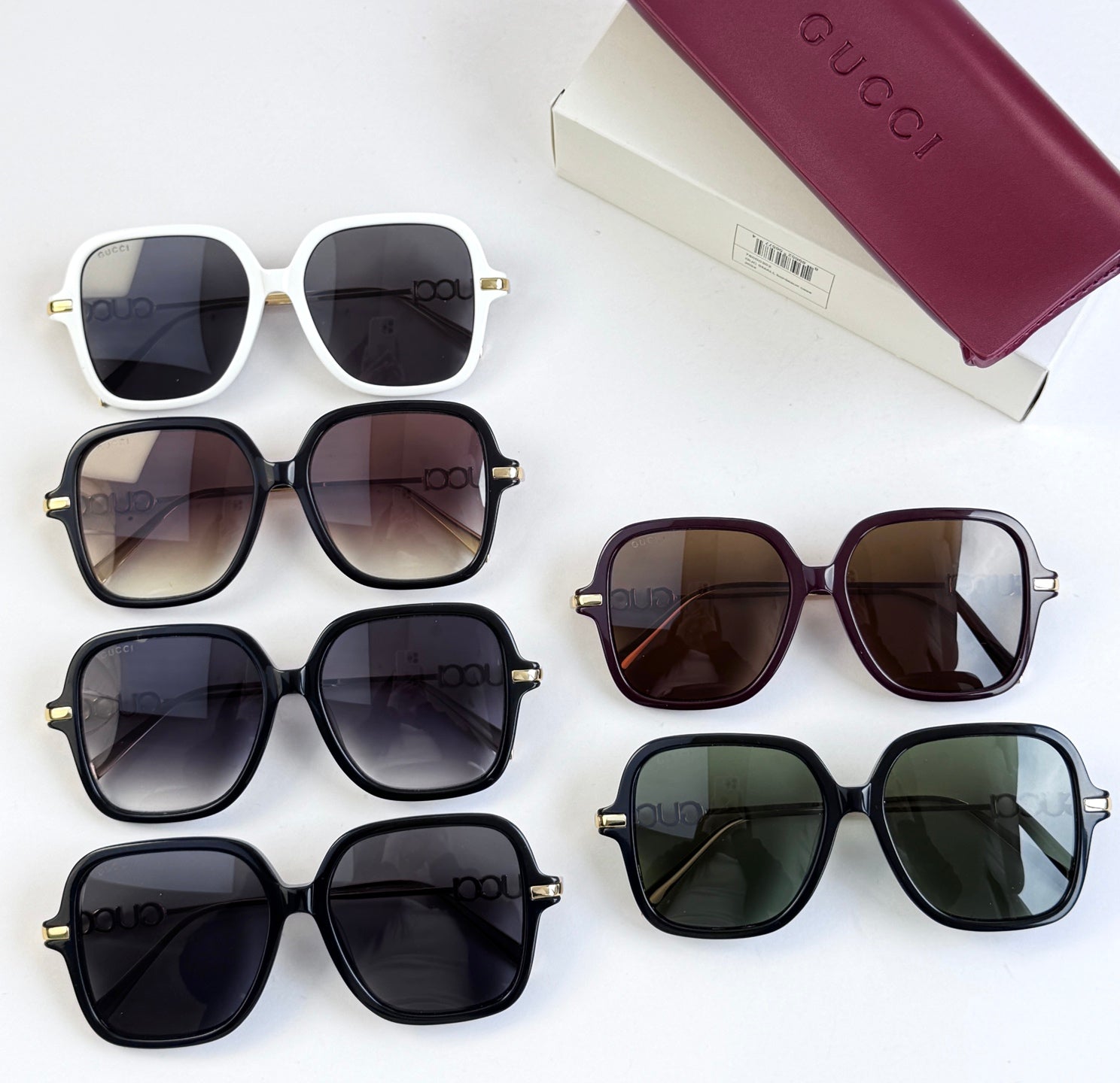 Multiple square sunglasses with assorted frames and tinted lenses on display