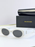 Sunglasses with white frames and dark round lenses