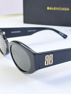 Sunglasses with black frames and dark lenses, temple and front angle