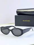 Balenciaga sunglasses with black oval frames and dark lenses
