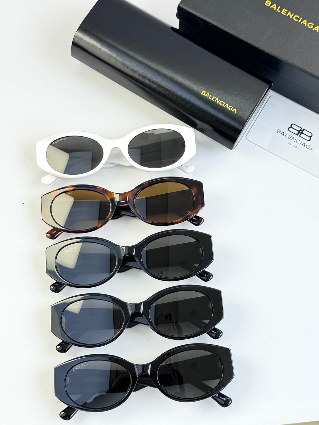 Sunglasses set with several styles: white, tortoiseshell, and dark blue pairs
