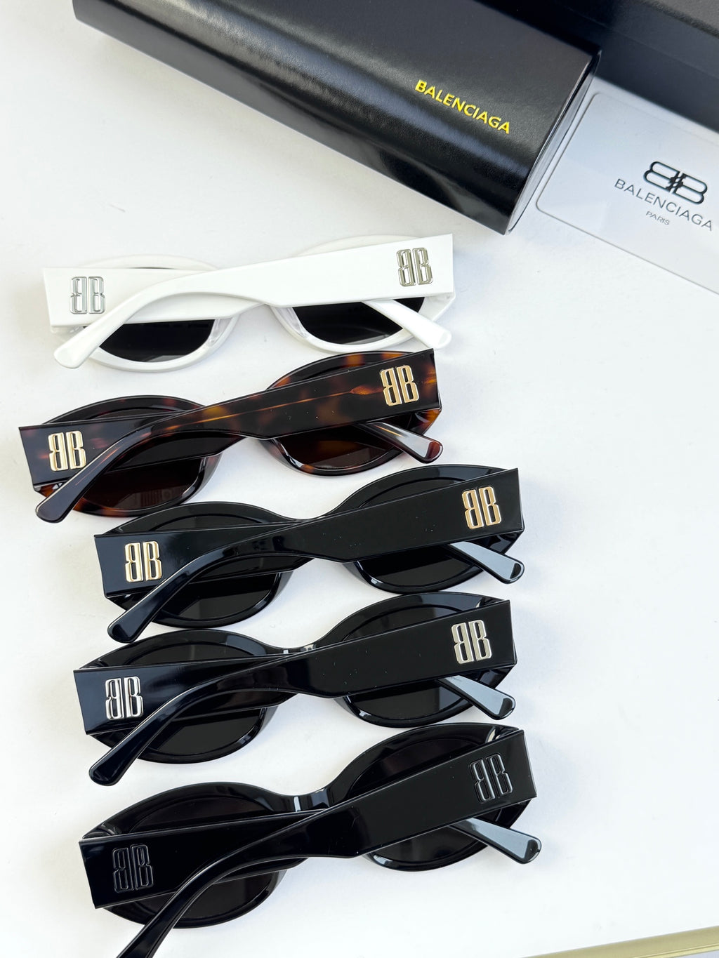 Sunglasses set with multiple frames: white, tortoiseshell, and black pairs