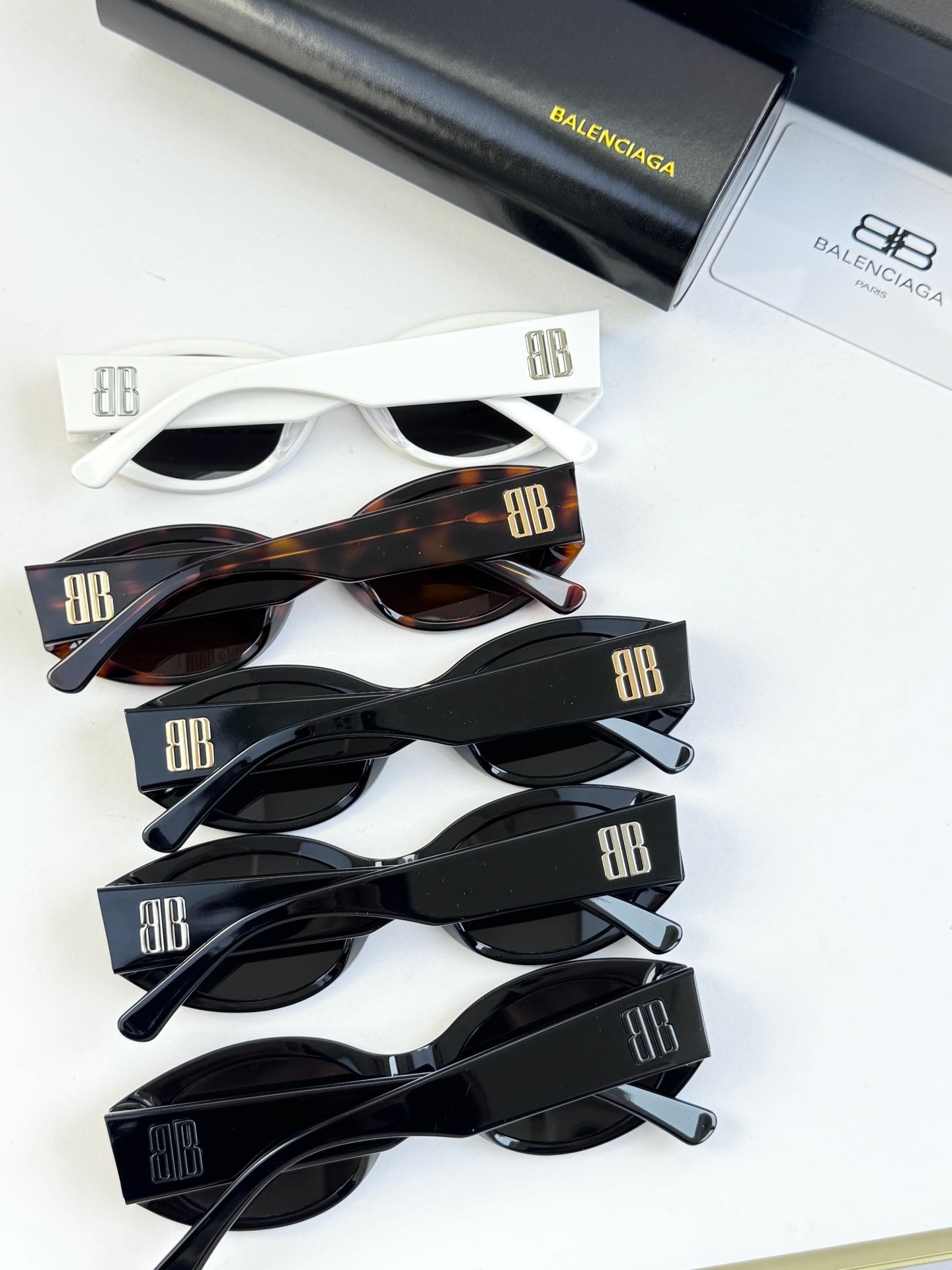 Sunglasses set with multiple frames: white, tortoiseshell, and black pairs
