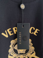 Versace T-shirt neckline close-up with hanging tag and gold crest