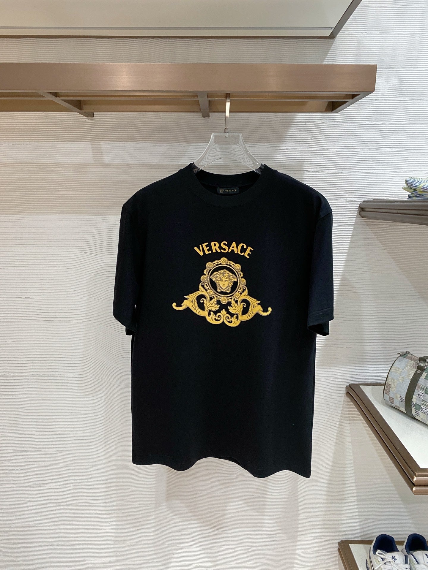 Versace T-shirt with dark fabric and gold VERSACE crest graphic