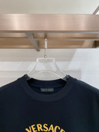 Versace T-shirt close-up with crew neck and partial gold VERSACE logo
