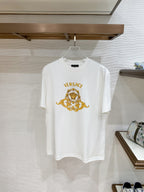 White crewneck T-shirt with gold Versace crest graphic on the front