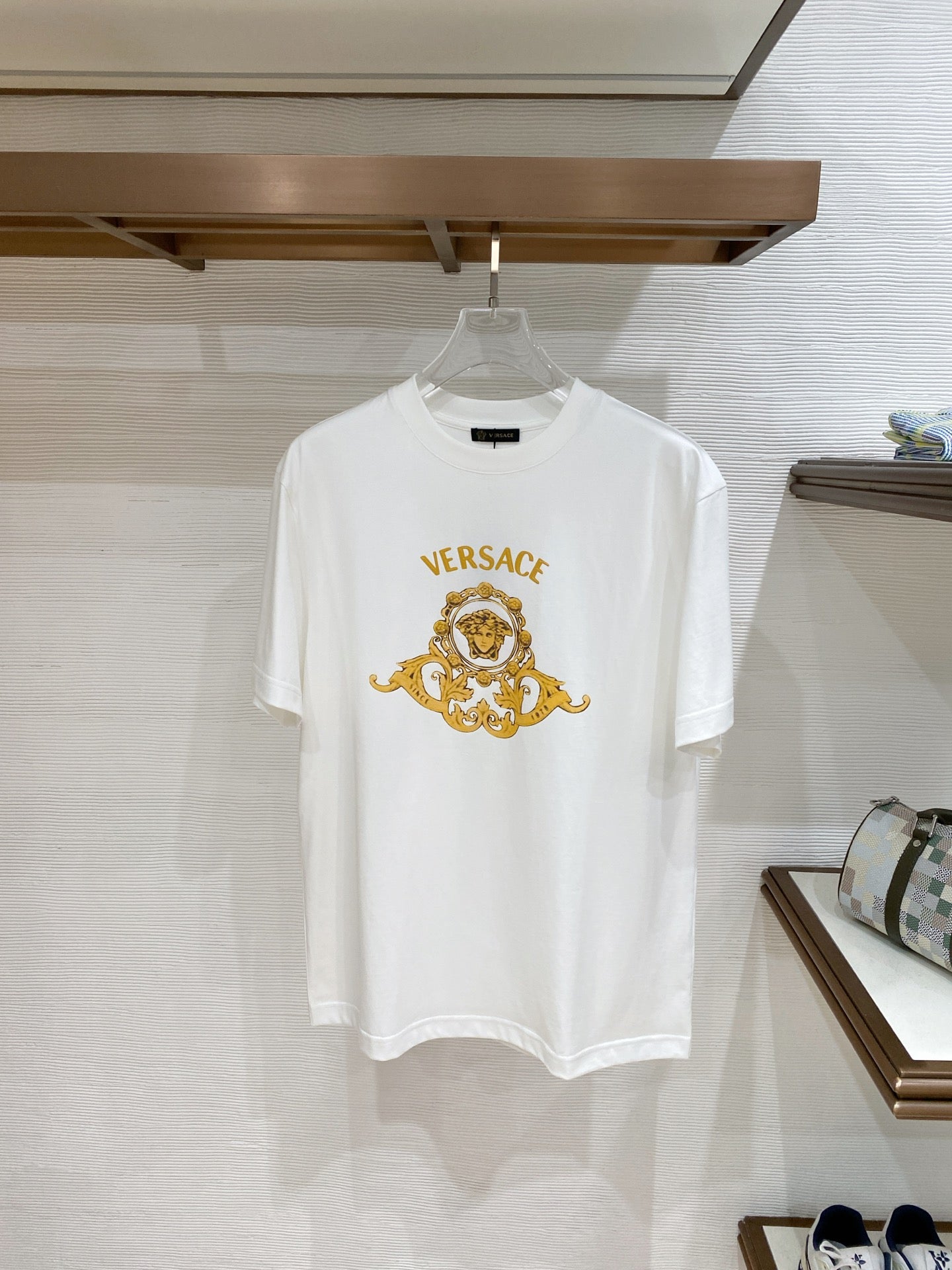 White T-shirt with gold baroque Medusa crest graphic on the chest