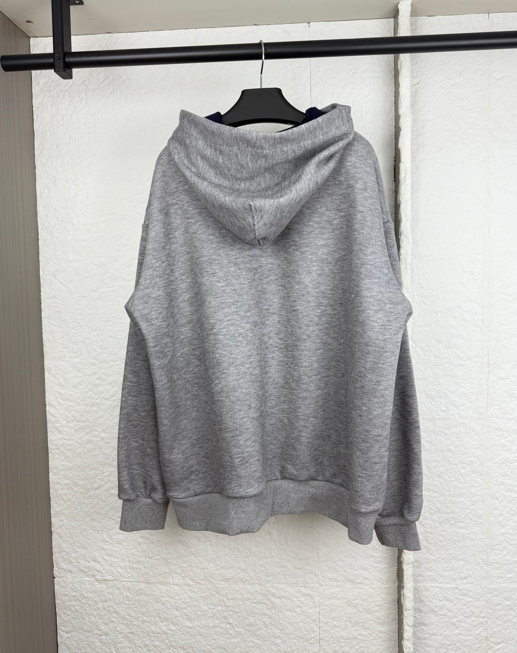 Gray marl pullover hoodie with hood and front pouch pocket, viewed from the back
