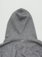 Gray hoodie with pullover hood and center seam detail at the crown