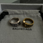 Balenciaga rings on fabric: silver-tone and gold-tone crest bands