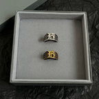 Balenciaga ring set in box: two crest rings in dark silver and gold