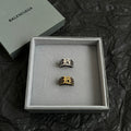 Balenciaga ring set in box: two crest rings, one dark silver and one gold