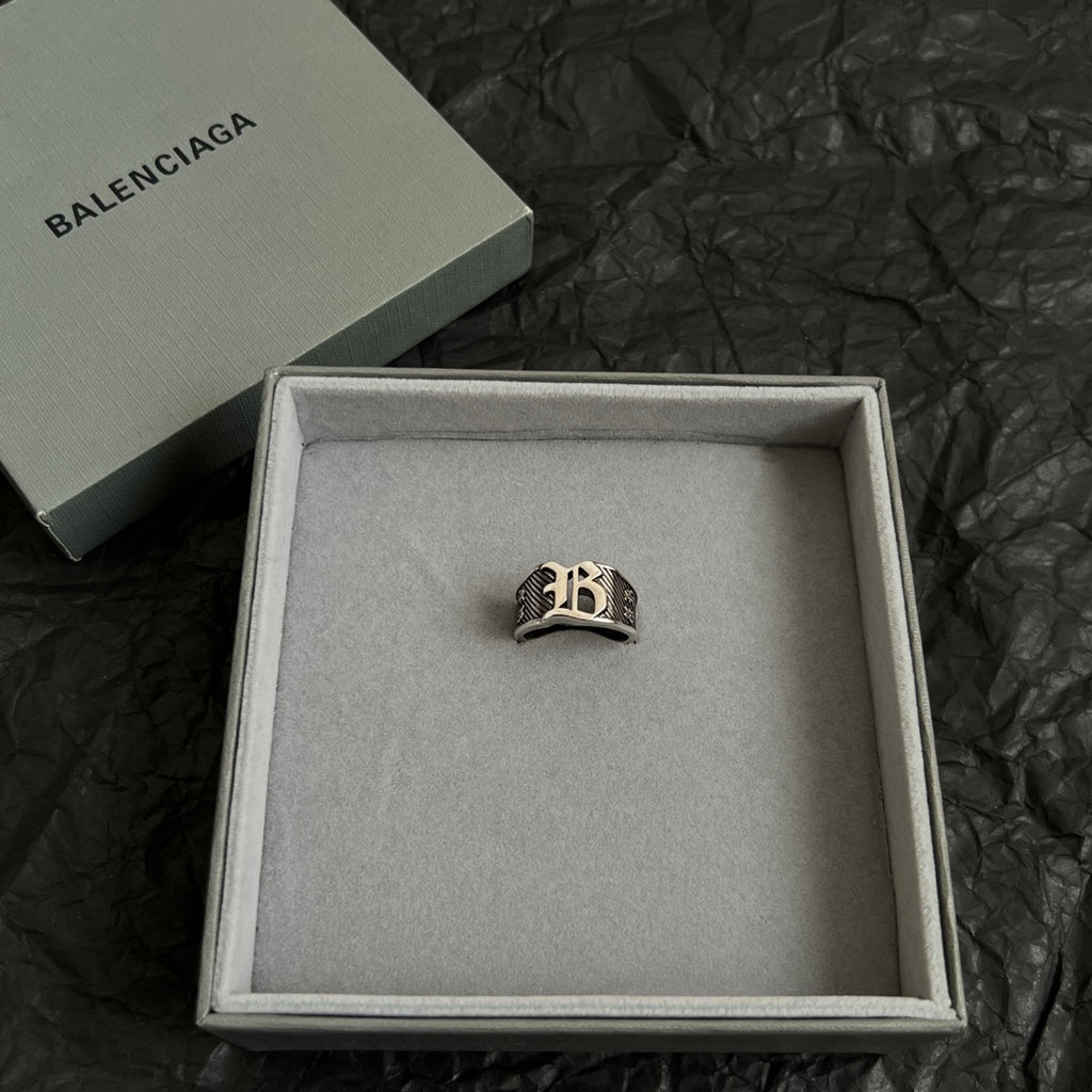 Silver-tone logo ring in an open gift box