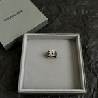 Silver-tone logo ring in an open gift box