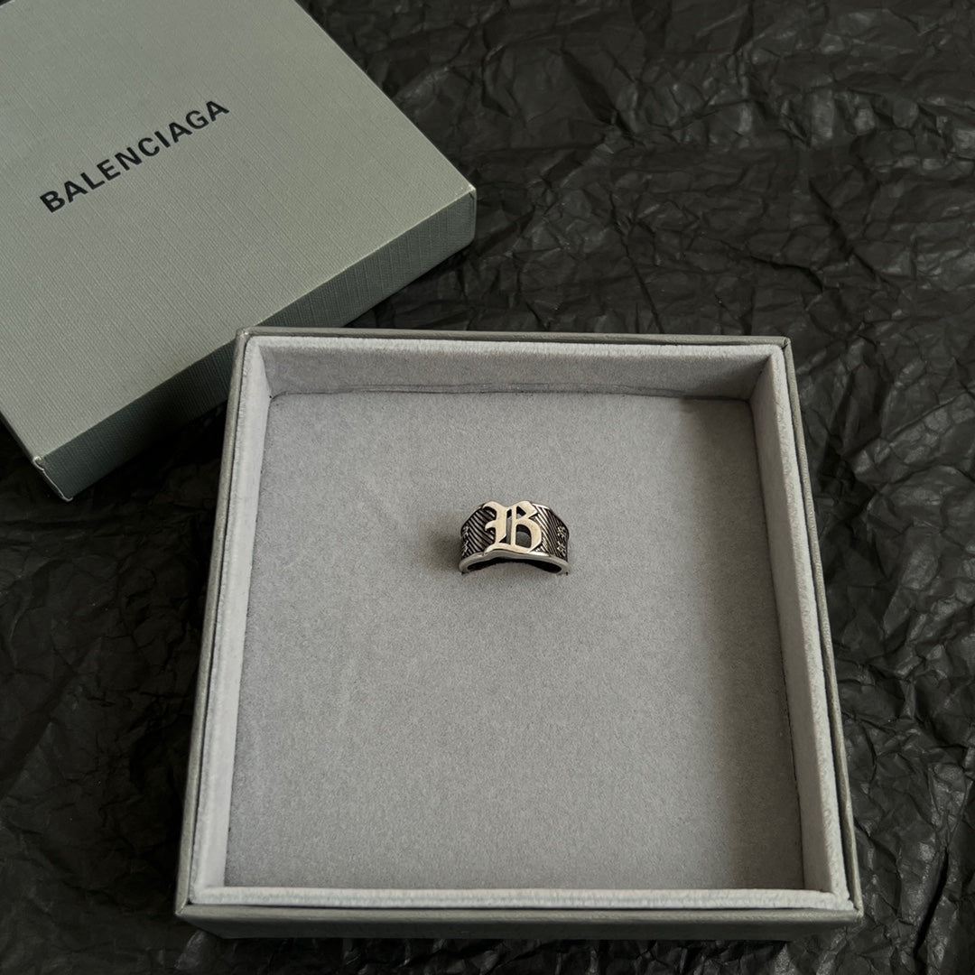 Silver-tone logo ring in an open gift box