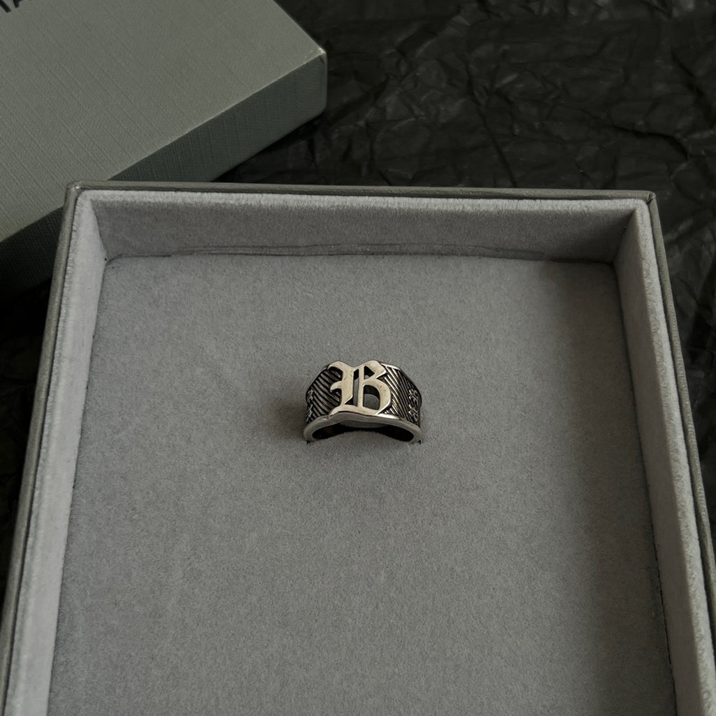 Silver-tone logo ring centered in open gift box