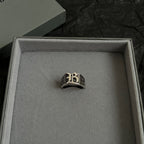 Silver-tone logo ring centered in open gift box