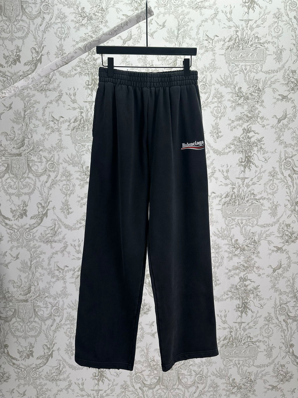 Balenciaga dark wide-leg pants with elastic waistband and logo patch