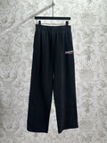 Balenciaga dark wide-leg pants with elastic waistband and logo patch