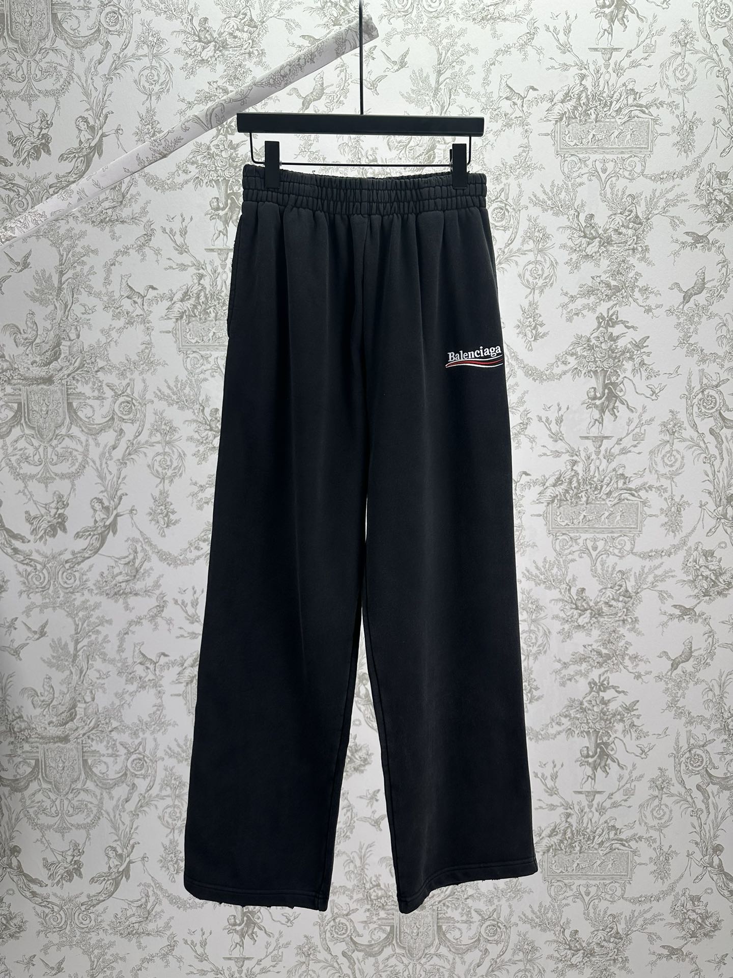 Balenciaga dark wide-leg pants with elastic waistband and logo patch