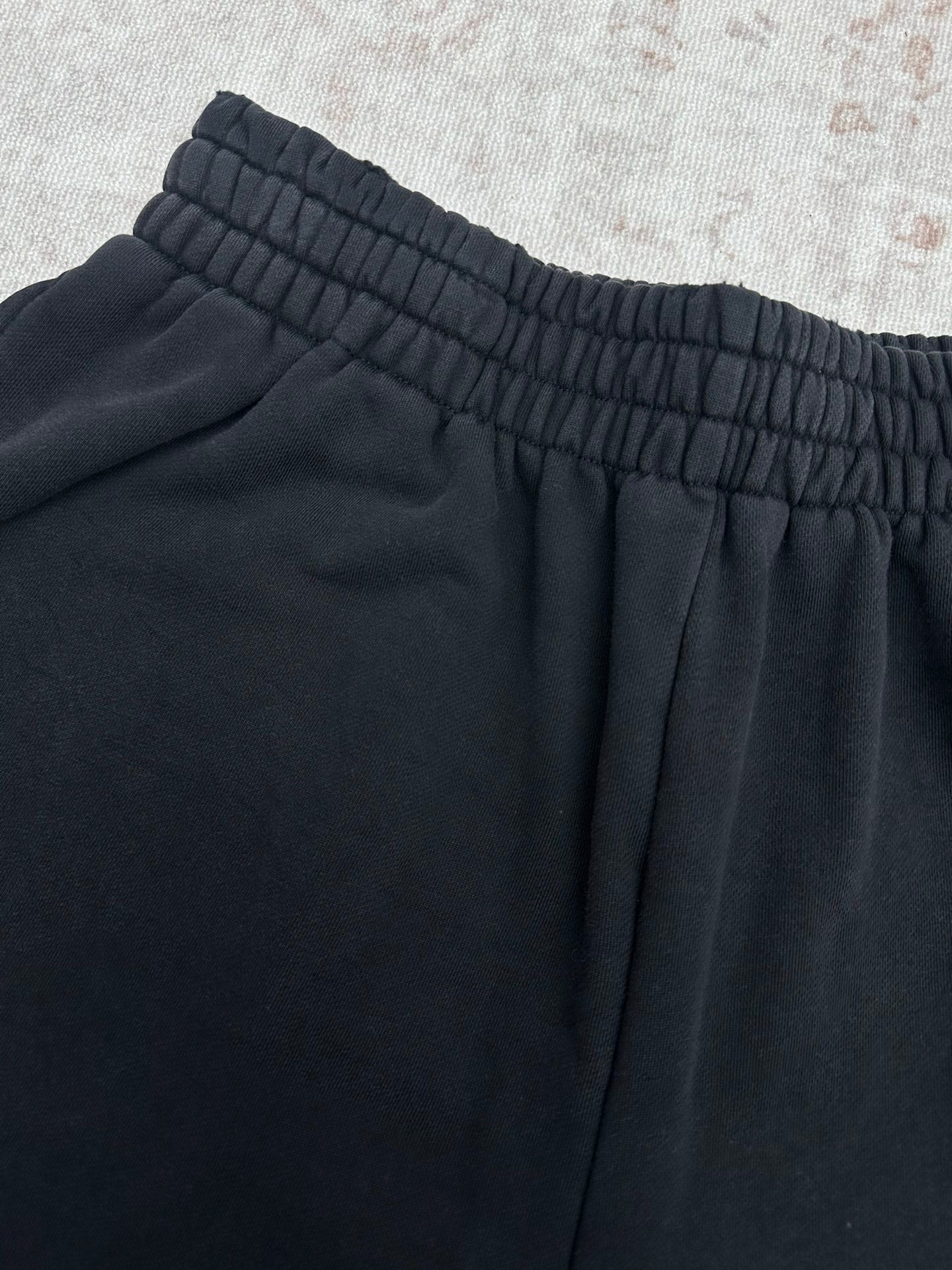 Balenciaga dark pants with elastic waistband and gathered fabric