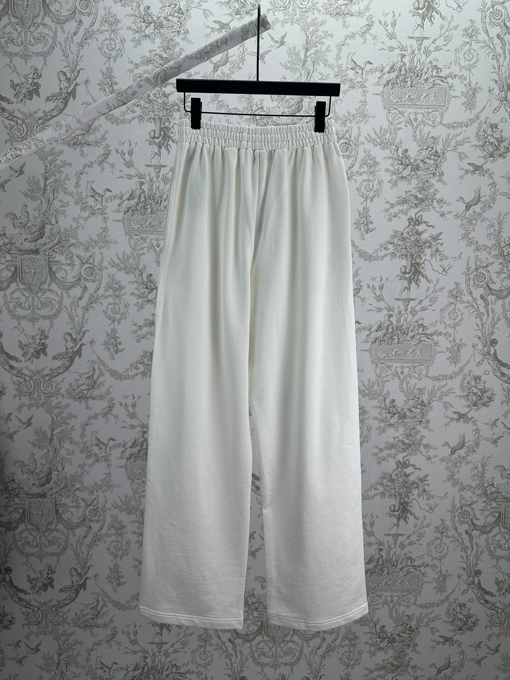 White wide-leg pants with elastic waistband and relaxed drape, front view.