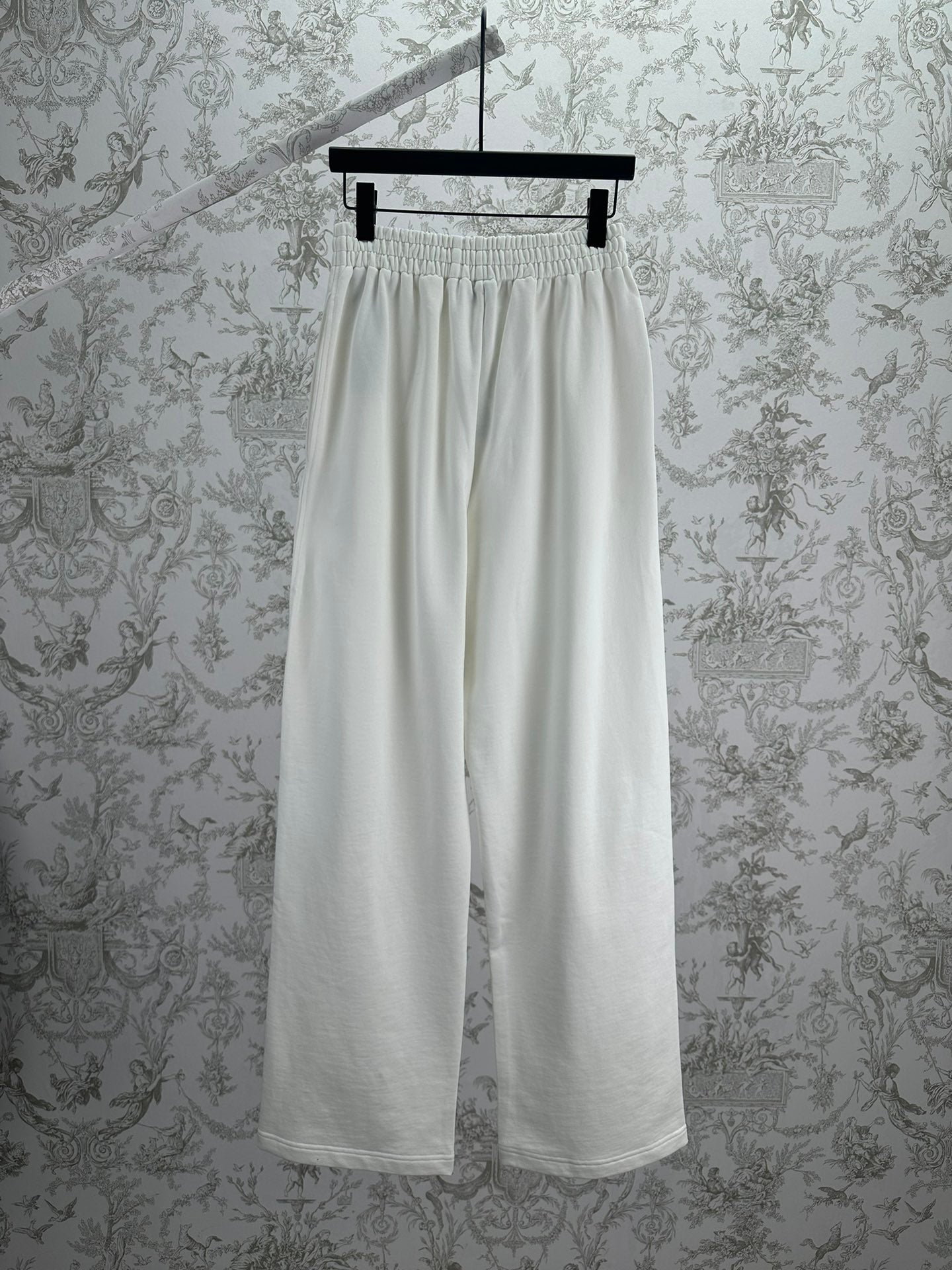 White wide-leg pants with elastic waistband and relaxed drape, front view.
