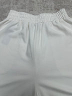 White wide-leg pants with elastic waistband and vertical seam lines, front view.