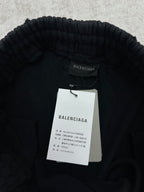 Black Balenciaga pants waistband with brand label and hanging tags