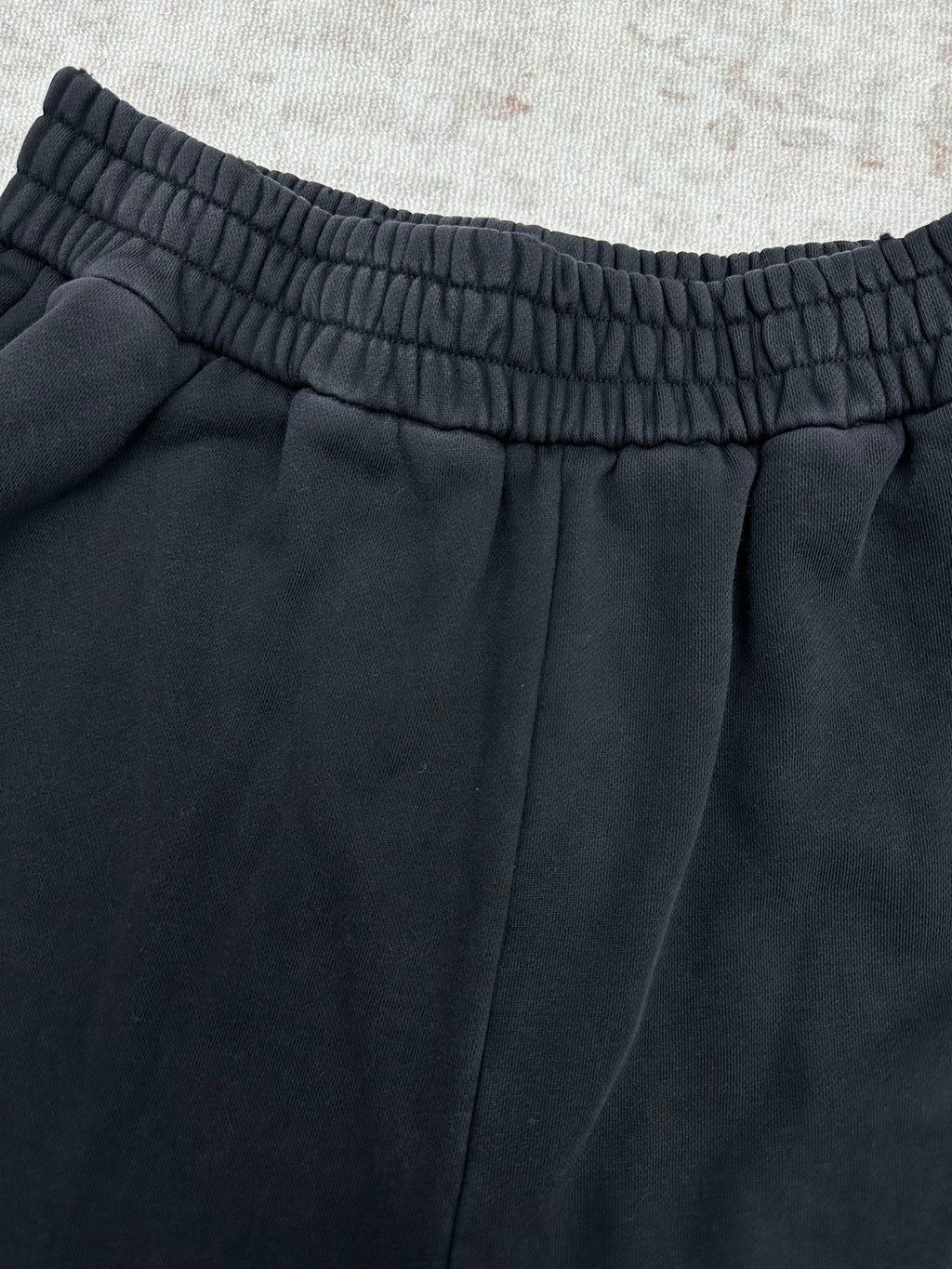 Black pants with elastic waistband and center front pleats