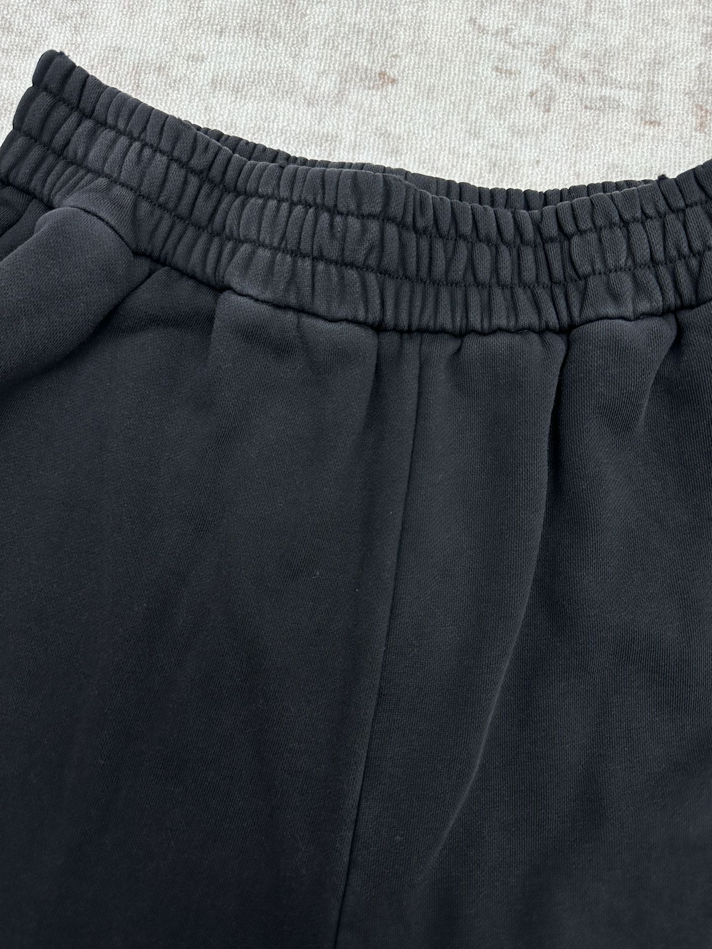 Black pants with elastic waistband and center front pleats