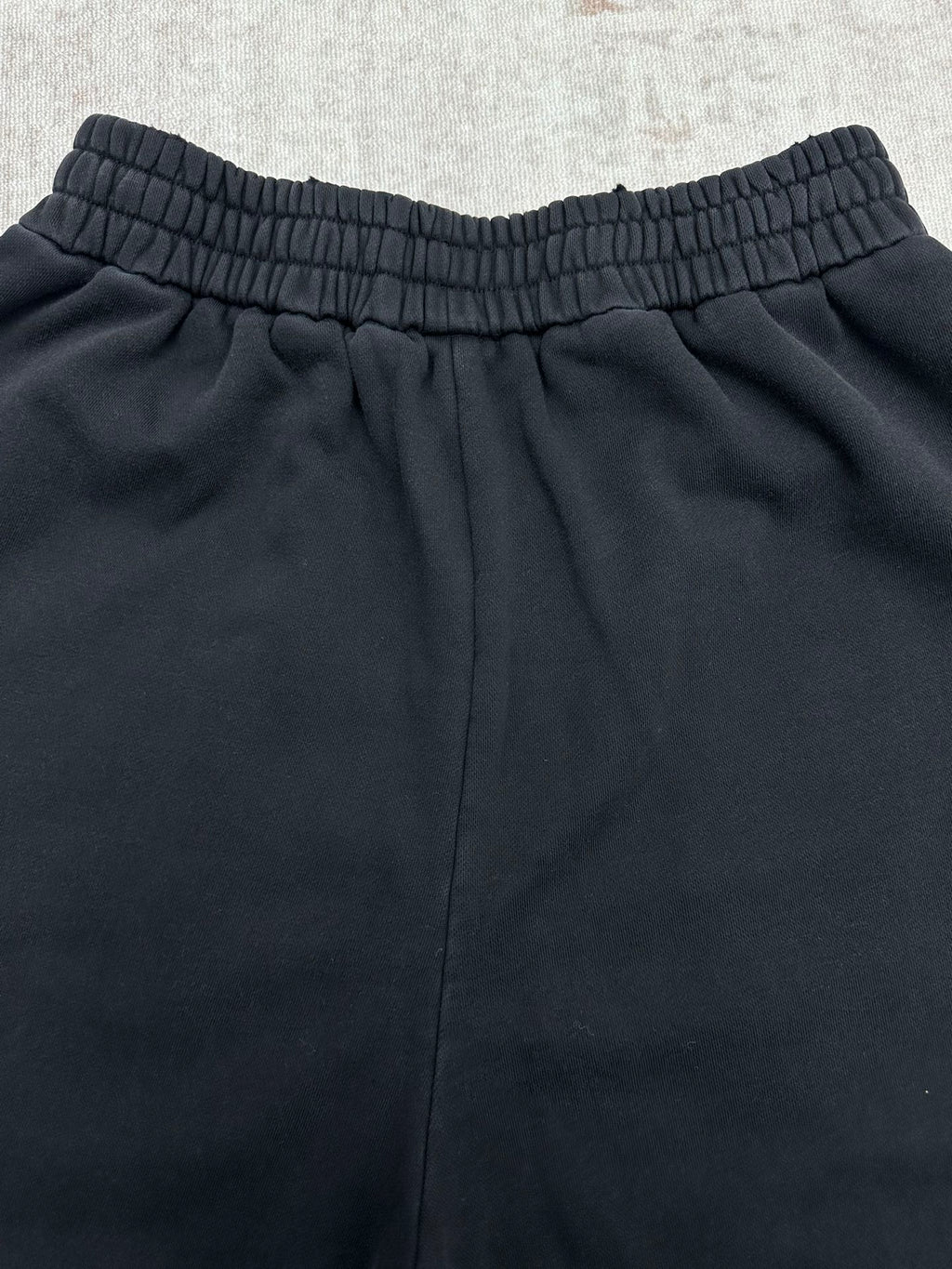 Black pants back view with elastic waistband and relaxed leg