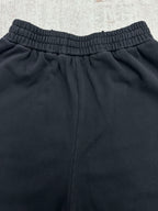 Black pants back view with elastic waistband and relaxed leg