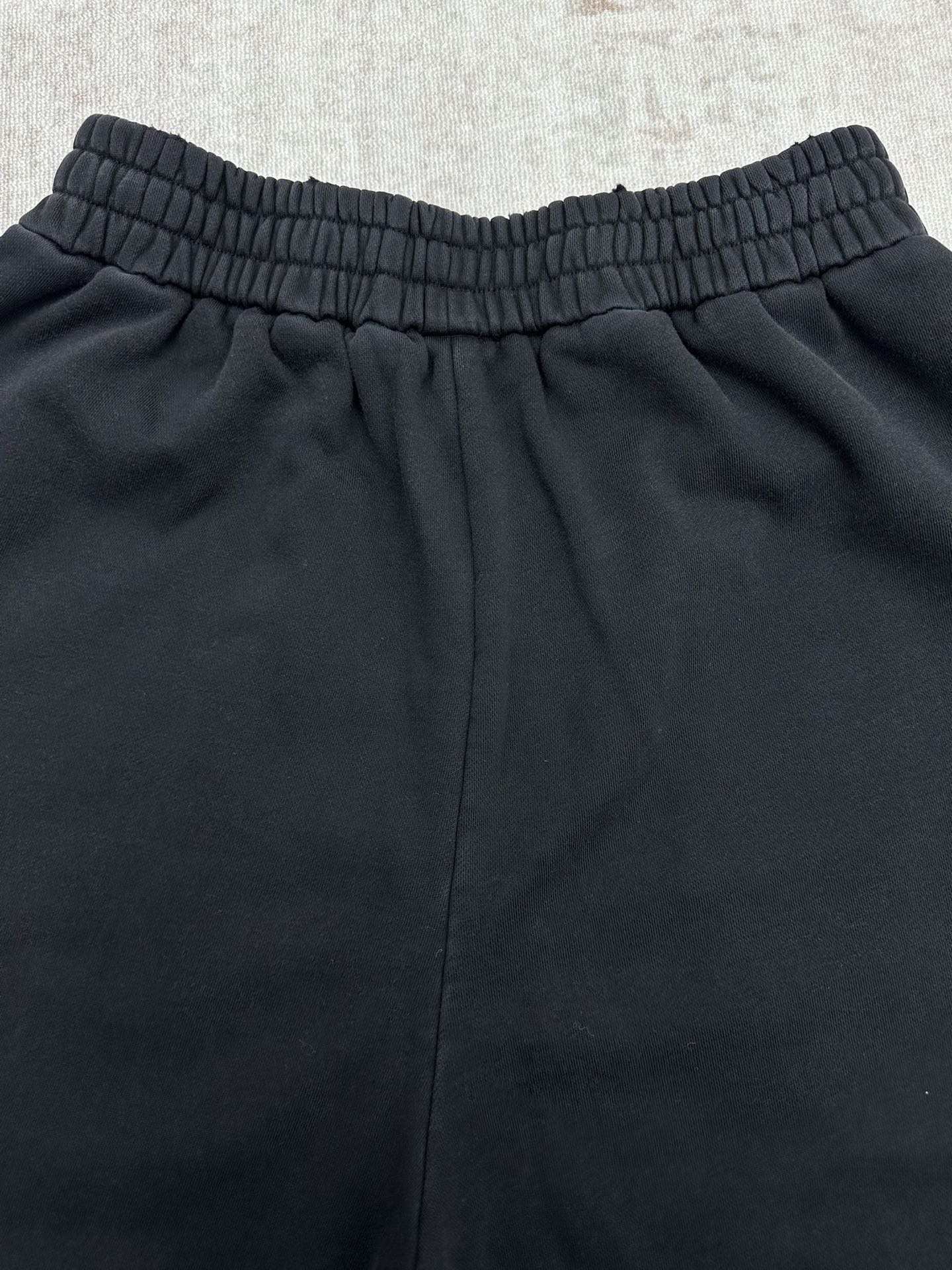 Black pants back view with elastic waistband and relaxed leg