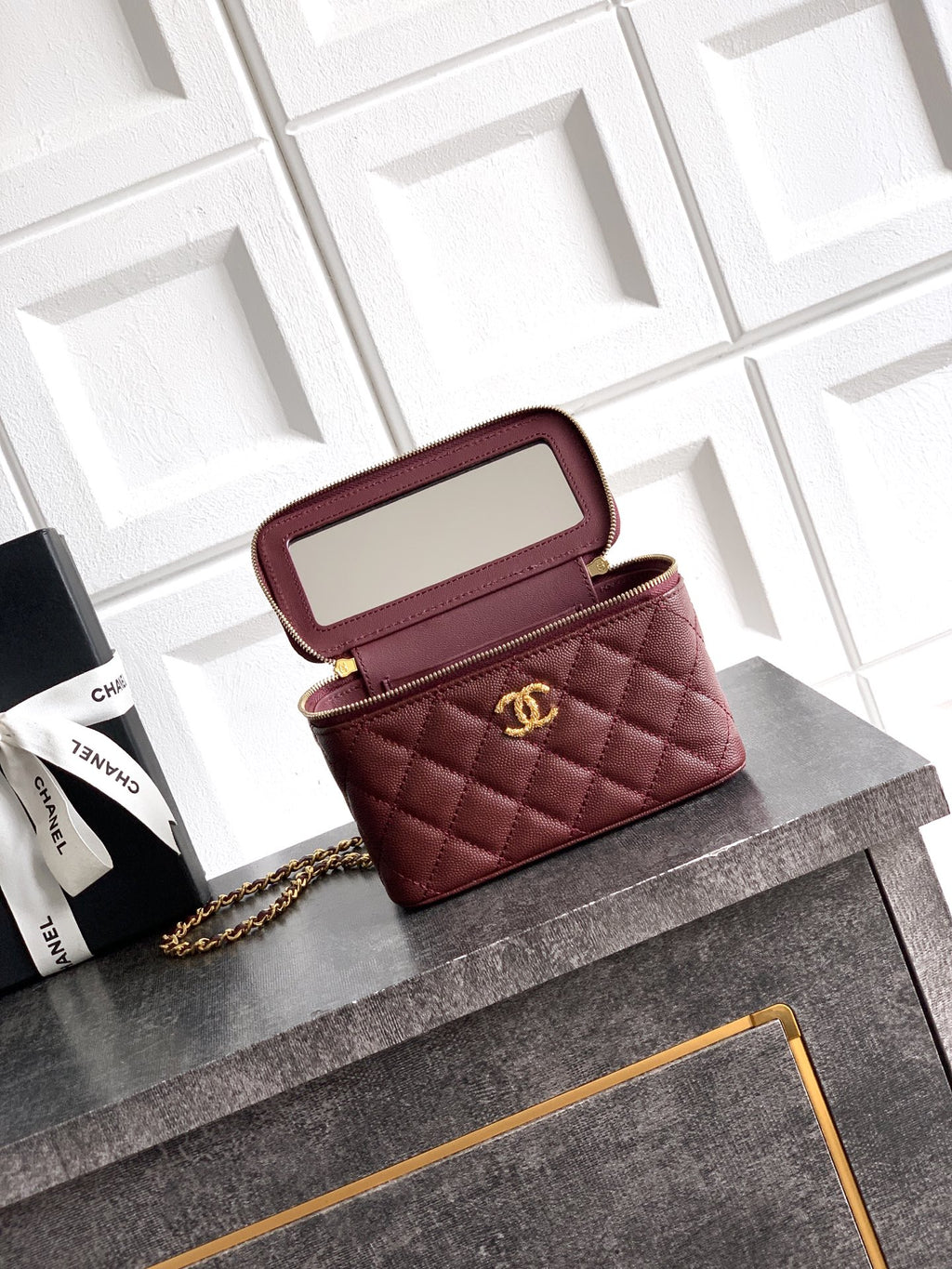 Burgundy Chanel mini flap bag opened view with gold zipper and chain strap