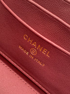 Burgundy Chanel leather label with gold text and stitching detail; MADE IN ITALY