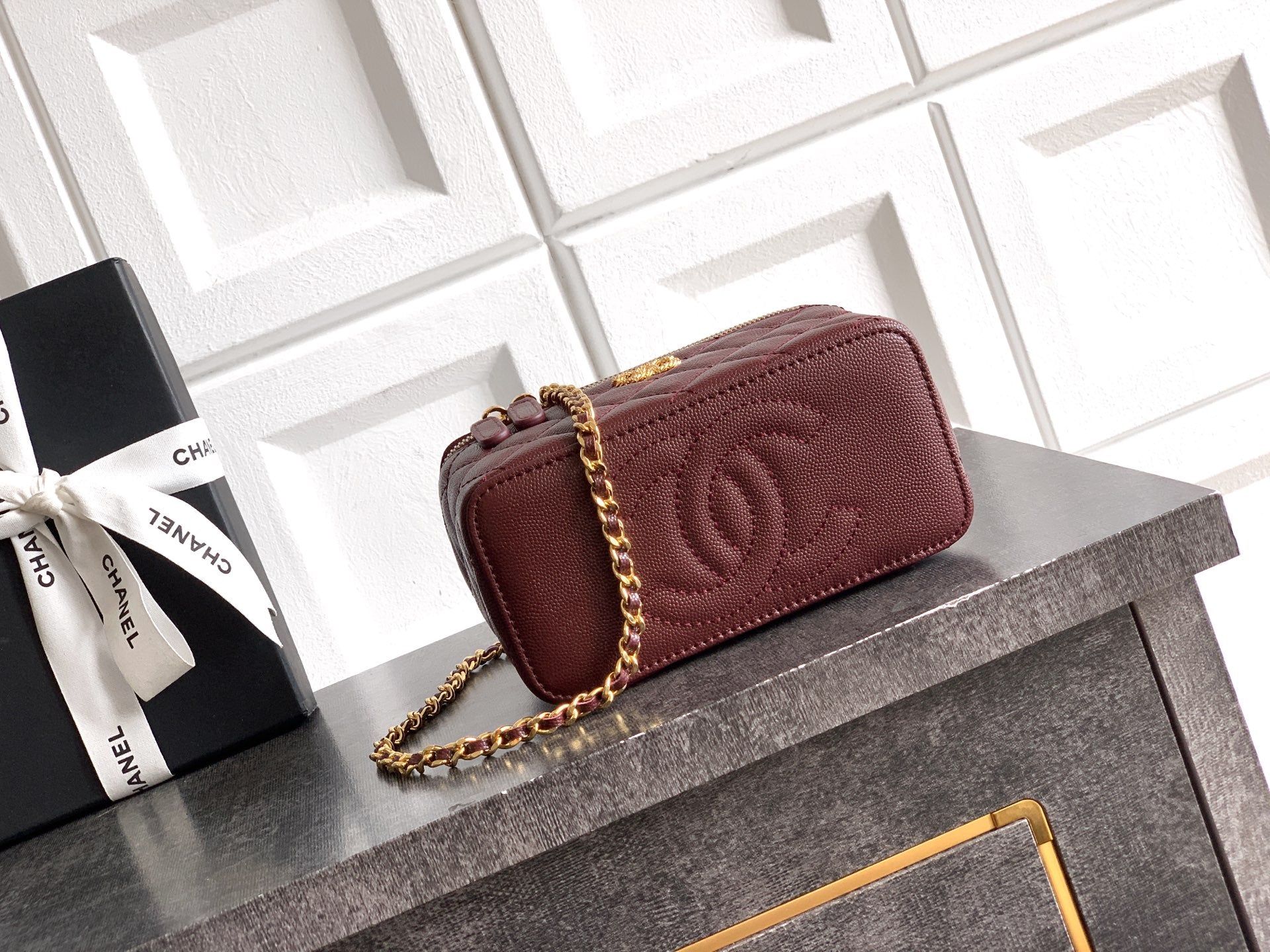 Burgundy Chanel mini quilted flap bag with CC logo and gold chain