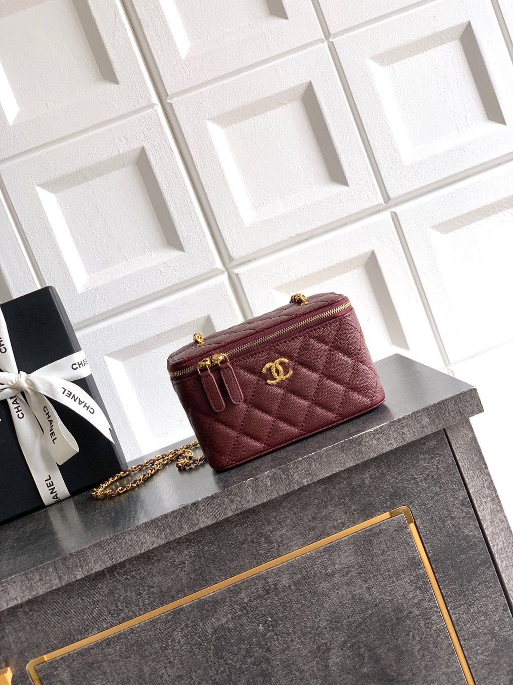 Quilted burgundy Chanel mini flap bag with gold chain crossbody strap