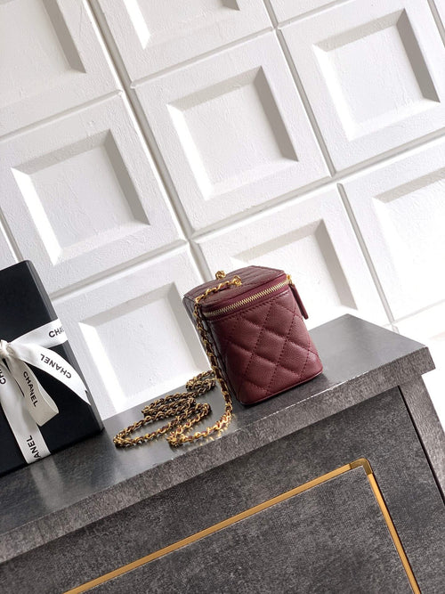 Burgundy Chanel mini bag with quilted texture and gold chain shoulder strap