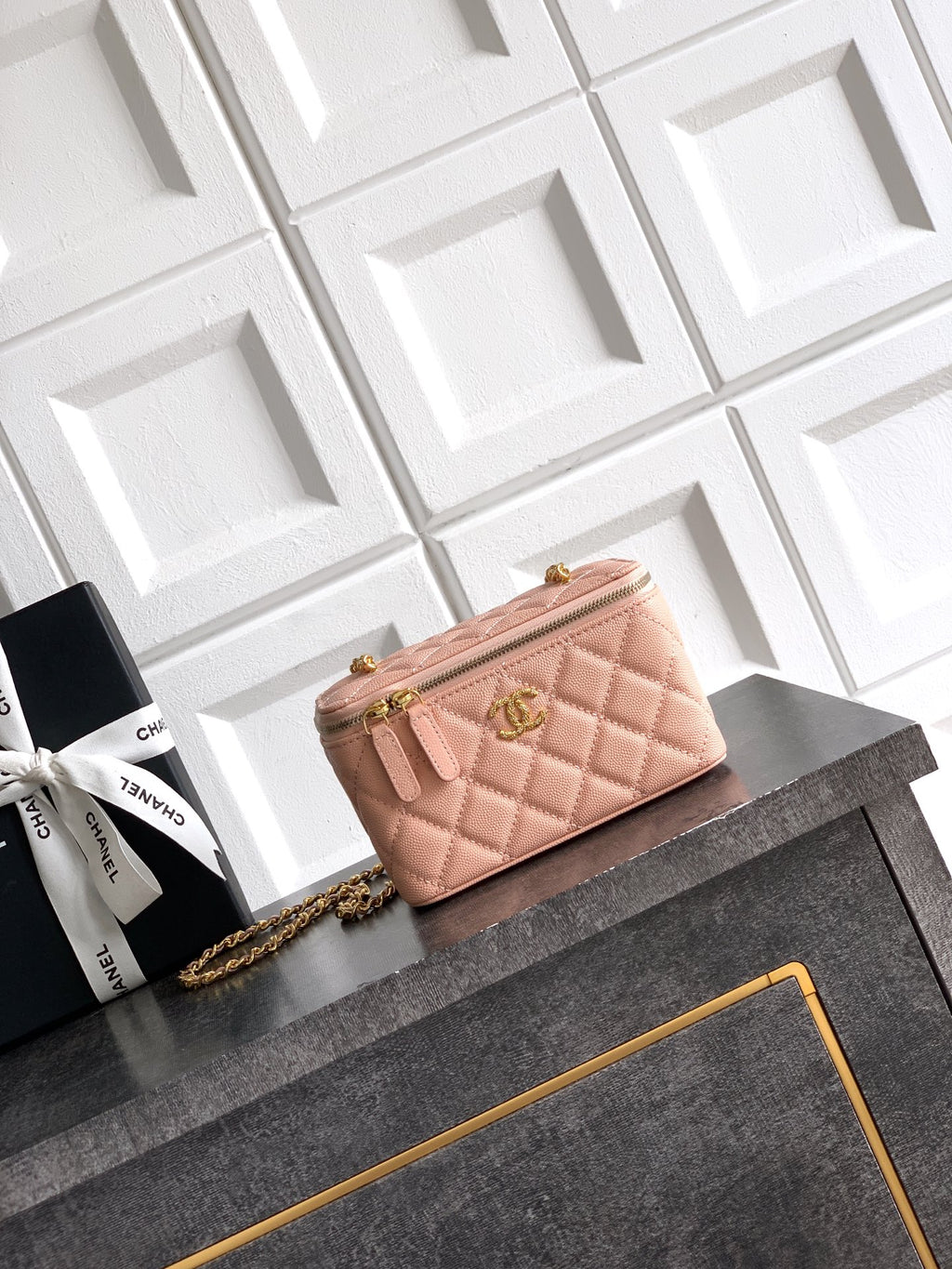 Chanel bag in light pink quilted leather with gold chain strap and top zip