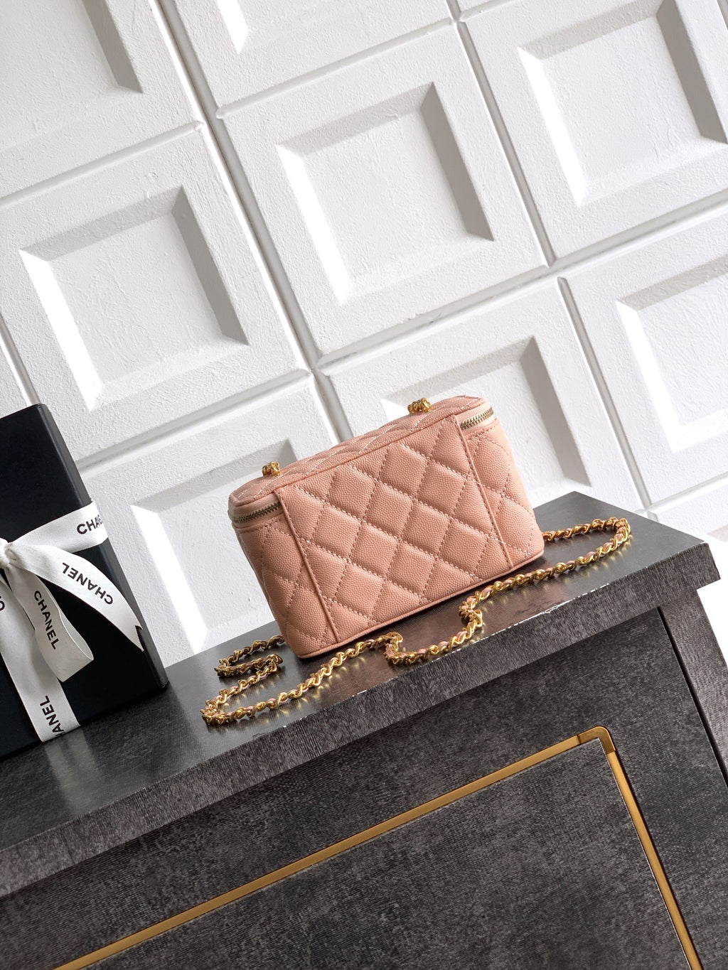 Chanel bag in light pink quilted leather with gold chain strap and front CC logo