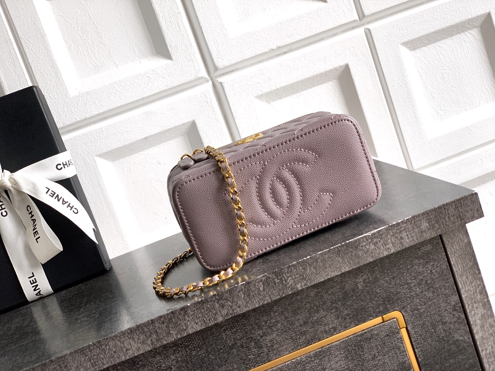 Lilac quilted Chanel mini bag with embossed CC logo and gold-tone chain