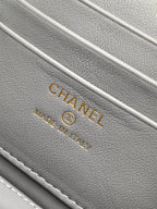 Gray fabric lining with CHANEL and trademark text on a lilac bag