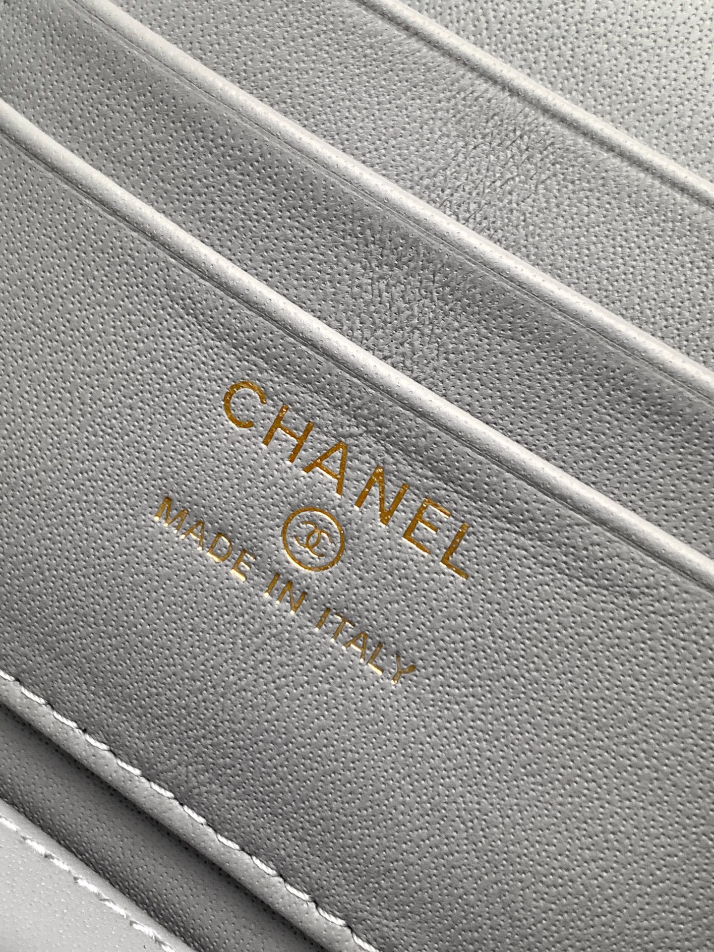 Gray fabric lining with CHANEL and trademark text on a lilac bag