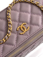 Close-up of lilac quilted bag front with gold-tone Chanel CC logo